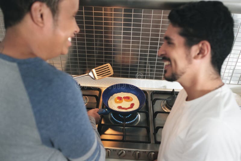 Gay Men Eating Breakfast Cooking Eggs In Home Kitchen stock images Gay Men Eating Breakfast Cooking Eggs In Home Kitchen stock images
