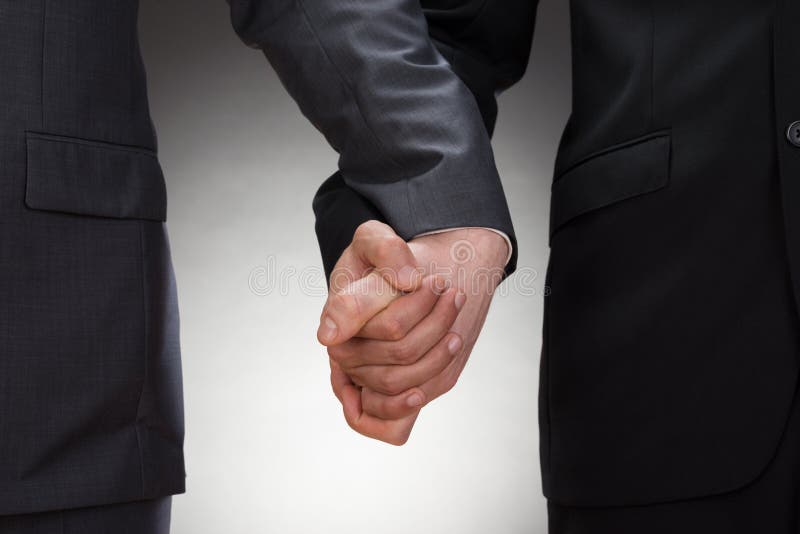 Close-up Of Two Gay Men Holding Hands. Male hand holding businessman stock images, royalty-free photos and pictures