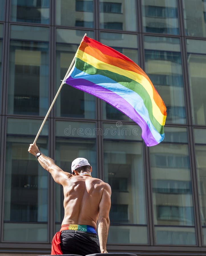 gay-pride-flag-waving-man-rainbow-parade