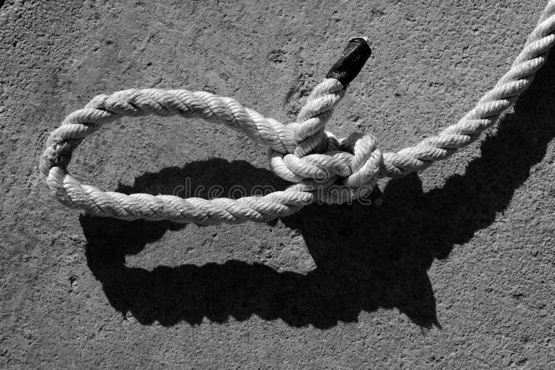 Black and white bowline gauze on marine rope and shadow. Black and white bowline gauze on marine rope and shadow