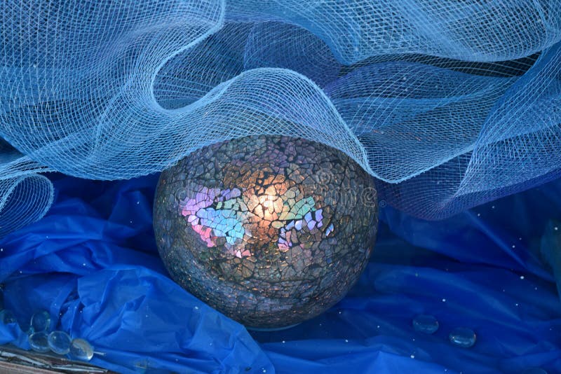Gazing ball with netting and blue crete paper
