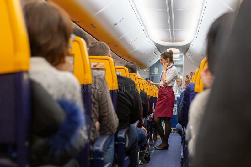 Gdansk Poland Paris France 12 19 2019 Flight. Stewardess and passengers in airplane cabin airline Raynair lowcost.Stock photo