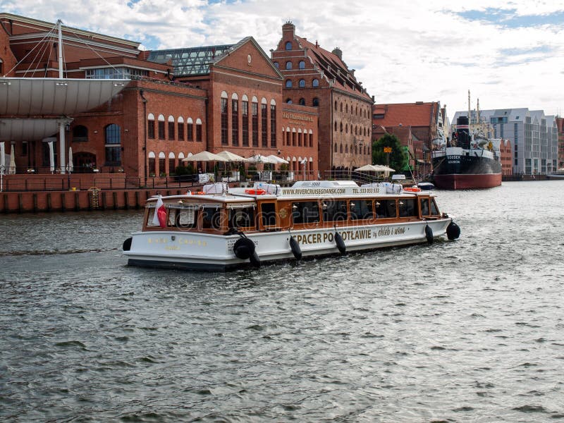 Tourist cruise ship on Motlawa river in historical Old Town of Gdansk City