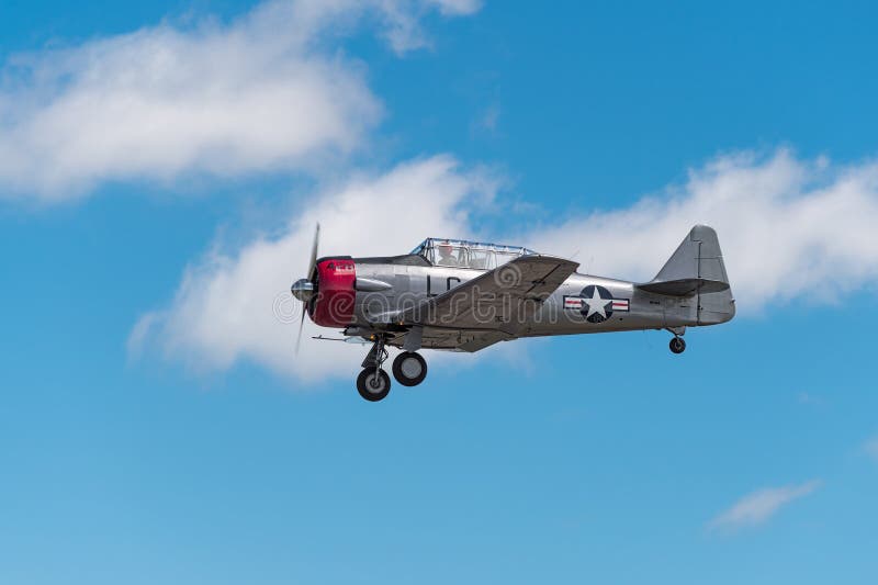 EDEN PRAIRIE, MN - JULY 16, 2016: AT-6 Texan airplane comes in for a landing with gear down at air show. The AT-6 Texan was primarily used as trainer aircraft during and after World War II. EDEN PRAIRIE, MN - JULY 16, 2016: AT-6 Texan airplane comes in for a landing with gear down at air show. The AT-6 Texan was primarily used as trainer aircraft during and after World War II.