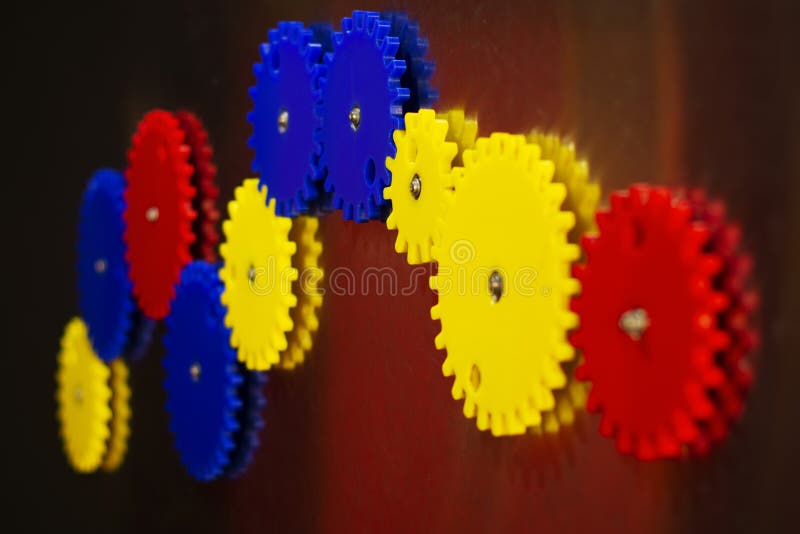 Gear mechanism for logical development of children on a magnet of different colors-red, blue, yellow royalty free stock photos Gear mechanism for logical development of children on a magnet of different colors-red, blue, yellow royalty free stock photos