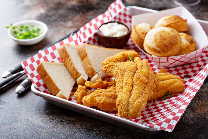 Fried catfish with cornbread dipped with buttermilk and seasoned with cornmeal, southern tradition. Fried catfish with cornbread dipped with buttermilk and seasoned with cornmeal, southern tradition