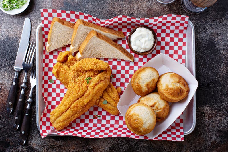 Fried catfish with cornbread dipped with buttermilk and seasoned with cornmeal, southern tradition. Fried catfish with cornbread dipped with buttermilk and seasoned with cornmeal, southern tradition