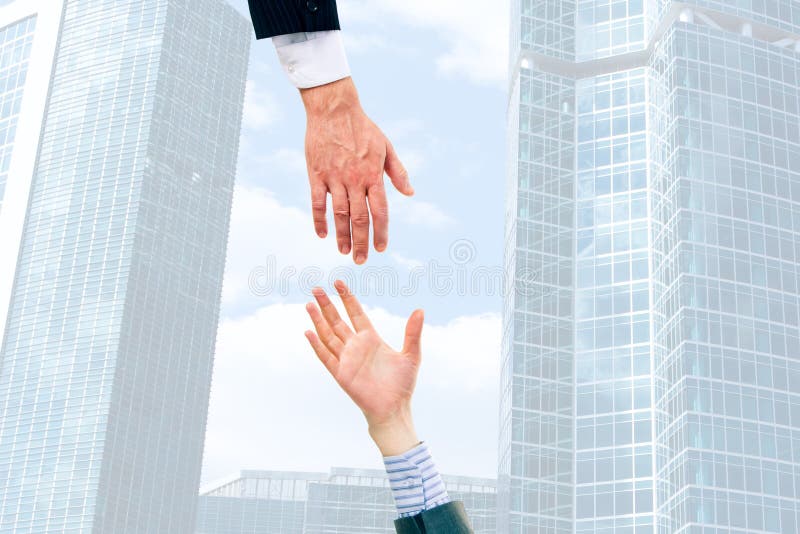 Image of two businesspeople giving hands each other. Image of two businesspeople giving hands each other