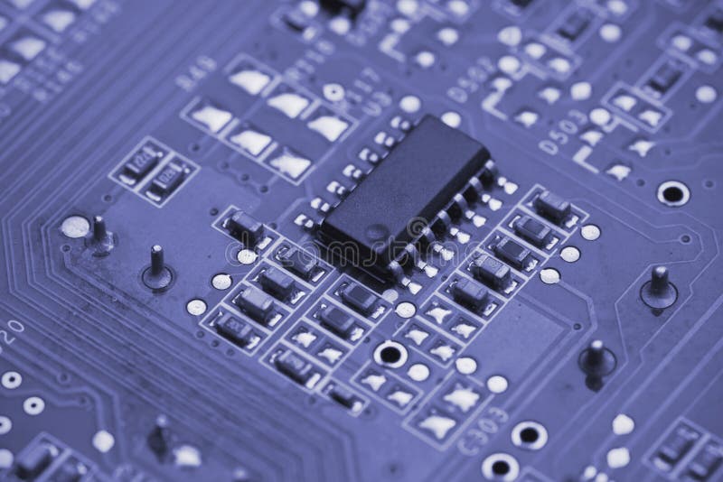 Macro shot of a printed circuit board with details of connection and chip. Macro shot of a printed circuit board with details of connection and chip