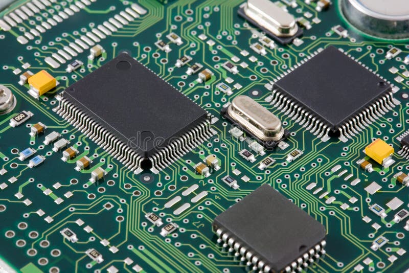 An electronics printed circuit baord showing surface mount components including quad flat pack ICs, resistors, capacitors and crystals. An electronics printed circuit baord showing surface mount components including quad flat pack ICs, resistors, capacitors and crystals.