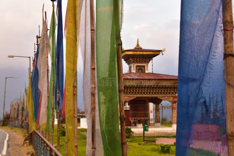 Bhutanese stupa with colorful prayer flags and clear blue sky