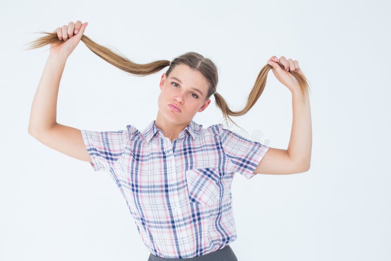 Geeky hipster holding her pigtails