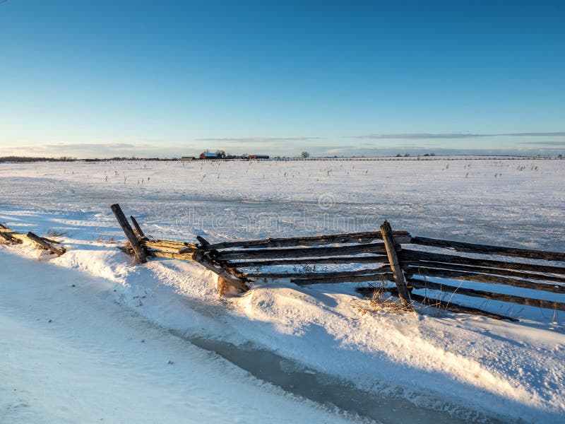 Frozen Winter Snow Cedar Rail Fence Country farm field in winter snow frozen landscape. Frozen Winter Snow Cedar Rail Fence Country farm field in winter snow frozen landscape