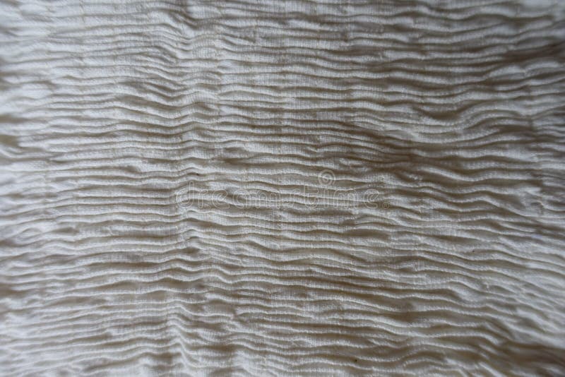 Shirred creamy white fabric with vertical seams. Shirred creamy white fabric with vertical seams