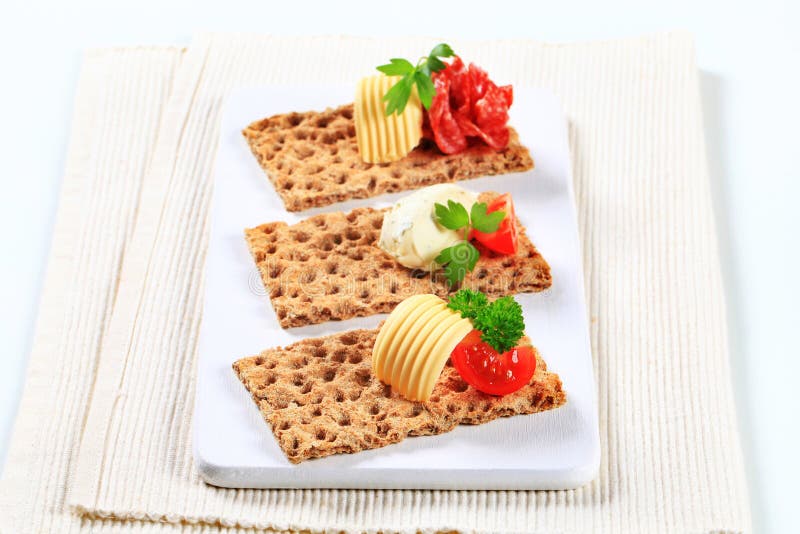 Geheel korrelknäckebrood met diverse bovenste laagjes royalty-vrije stock foto Geheel korrelknäckebrood met diverse bovenste laagjes royalty-vrije stock foto