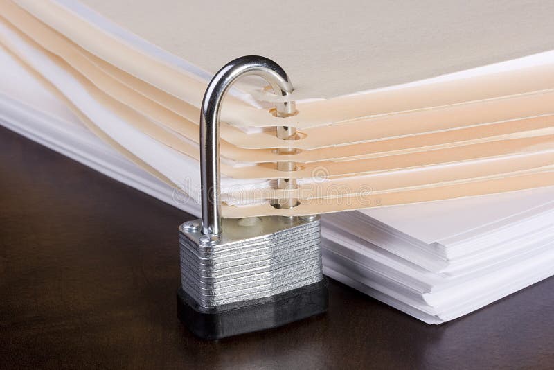 Stack of folders closed with a metal lock. Stack of folders closed with a metal lock.