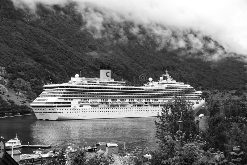 Geiranger, Norway - January 25, 2010: cruise ship in norwegian fjord. Travel destination, tourism. Adventure, discovery stock photography Geiranger, Norway - January 25, 2010: cruise ship in norwegian fjord. Travel destination, tourism. Adventure, discovery stock photography