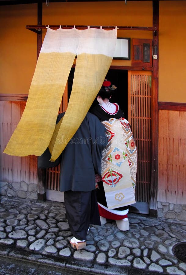 Geisha entering in a traditional wooden tea house from Gion,Kyoto,Japan.This is a specific moment when a new geisha(maiko) is presented to the tea houses masters in Gion. Usually it takes place during the spring season. Browse my complex. Geisha entering in a traditional wooden tea house from Gion,Kyoto,Japan.This is a specific moment when a new geisha(maiko) is presented to the tea houses masters in Gion. Usually it takes place during the spring season. Browse my complex