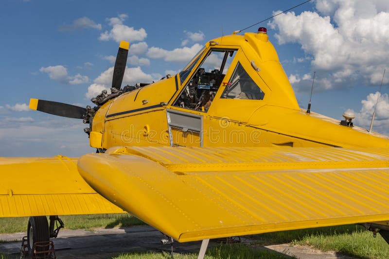 Yellow agricultural aircraft ready for flight, visible cockpit. Yellow agricultural aircraft ready for flight, visible cockpit