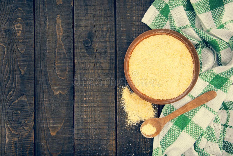Gelbes Maismehl in einer keramischen Schüssel auf einem rustikalen Holztisch Bestandteile für Vorbereitung eines italienischen tr stockfotografie Gelbes Maismehl in einer keramischen Schüssel auf einem rustikalen Holztisch Bestandteile für Vorbereitung eines italienischen tr stockfotografie