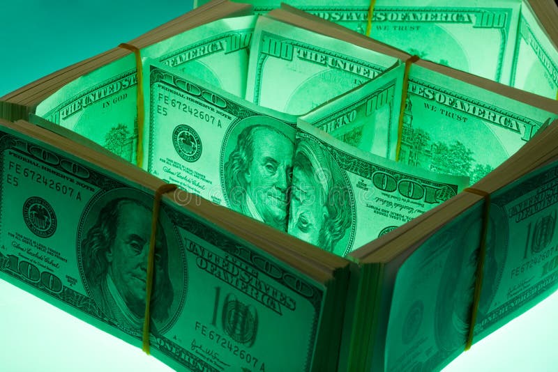 Close-up of house made of dollars with green highlight. Close-up of house made of dollars with green highlight