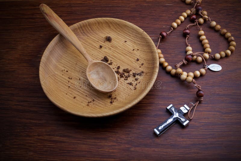 Fasting, Lent. Plate and cross on vintage wooden backgroud. Fasting, Lent. Plate and cross on vintage wooden backgroud.