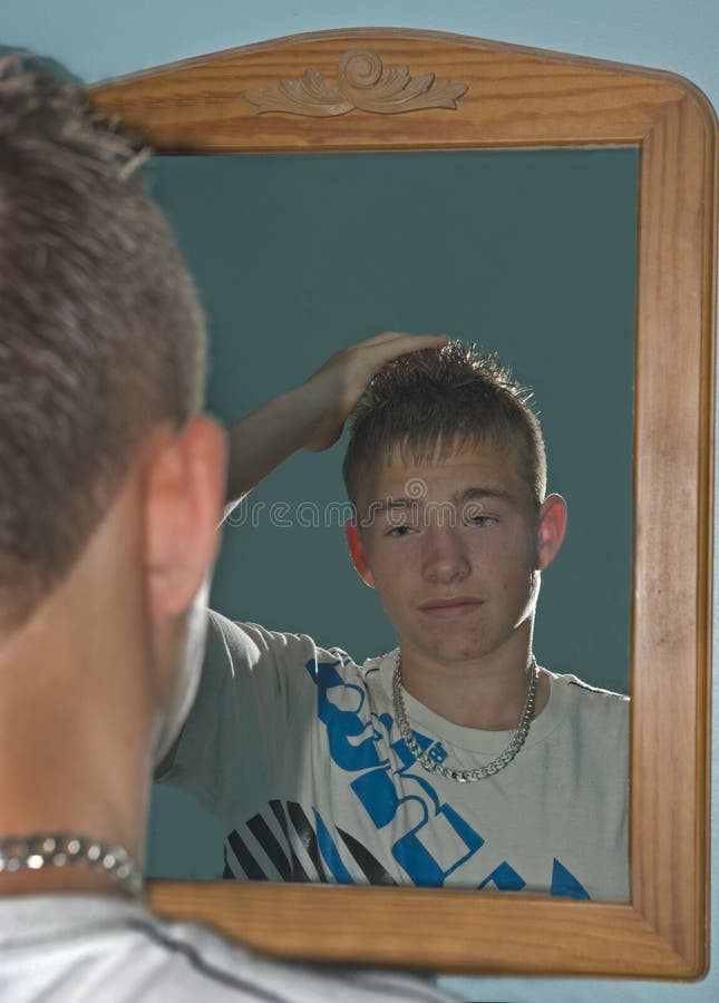 Boy Gelling his hair in the Mirror. Boy Gelling his hair in the Mirror.