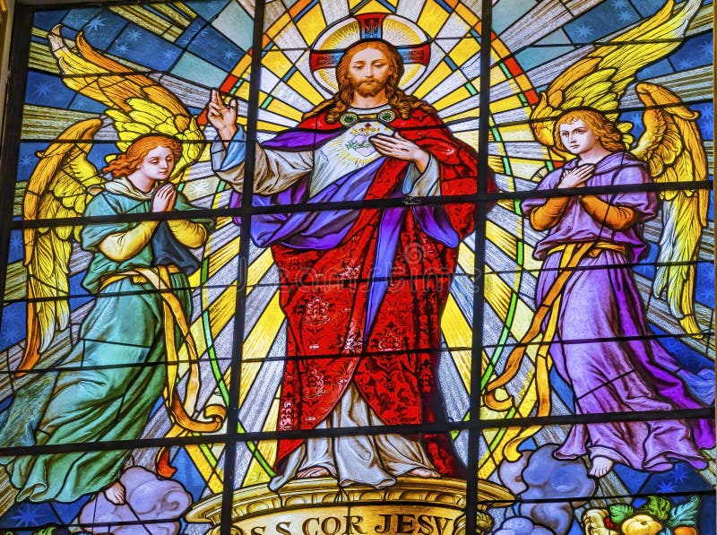 Colorful Jesus Archangels Stained Glass Basilica Cathedral Puebla Mexico. Church built in 15 to 1600s. Words say sacred heart of Jesus have mercy. Colorful Jesus Archangels Stained Glass Basilica Cathedral Puebla Mexico. Church built in 15 to 1600s. Words say sacred heart of Jesus have mercy