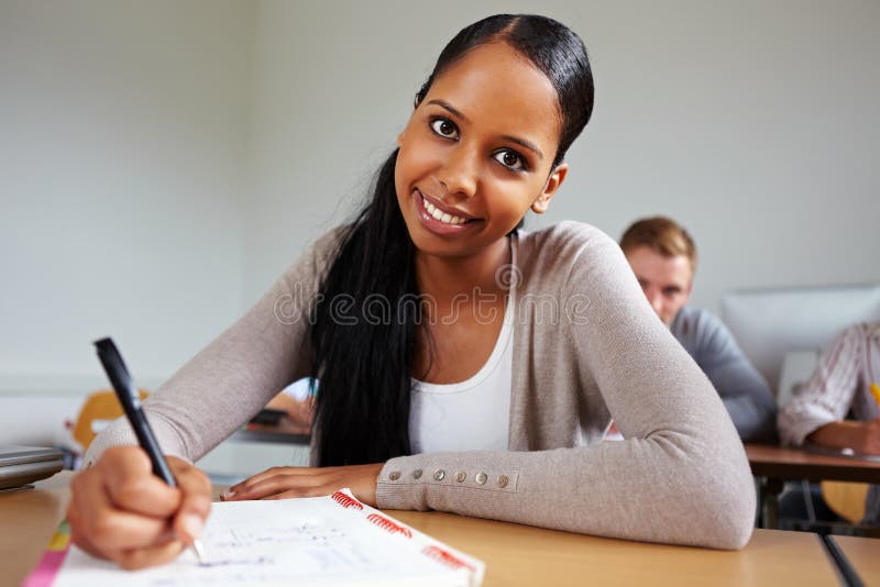 Happy african girl in school taking notes. Happy african girl in school taking notes