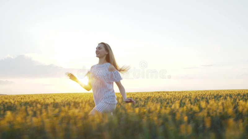 Gelukkig meisje in kleding die op een groen gebied van een jonge verkrachting 4K lopen