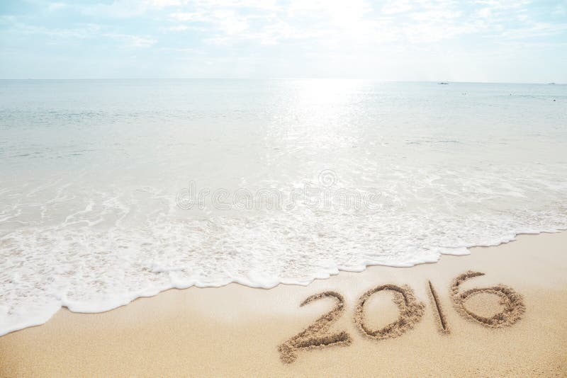 New Year 2016 is coming concept - inscription 2016 on a beach sand. New Year 2016 is coming concept - inscription 2016 on a beach sand