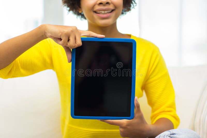 People, technology, advertisement and leisure concept - close up of happy african american young woman sitting on sofa and showing tablet pc computer black blank screen at home. People, technology, advertisement and leisure concept - close up of happy african american young woman sitting on sofa and showing tablet pc computer black blank screen at home