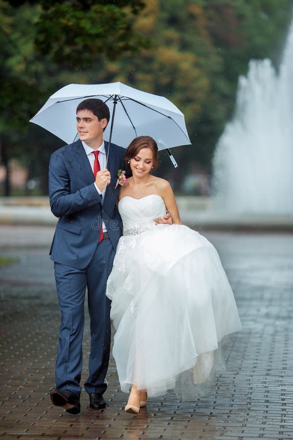 Doen Vrijwillig Monet Gelukkige Bruid En Bruidegom Bij De Witte Paraplu Van De Huwelijksgang  Stock Afbeelding - Image of park, mensen: 71191239