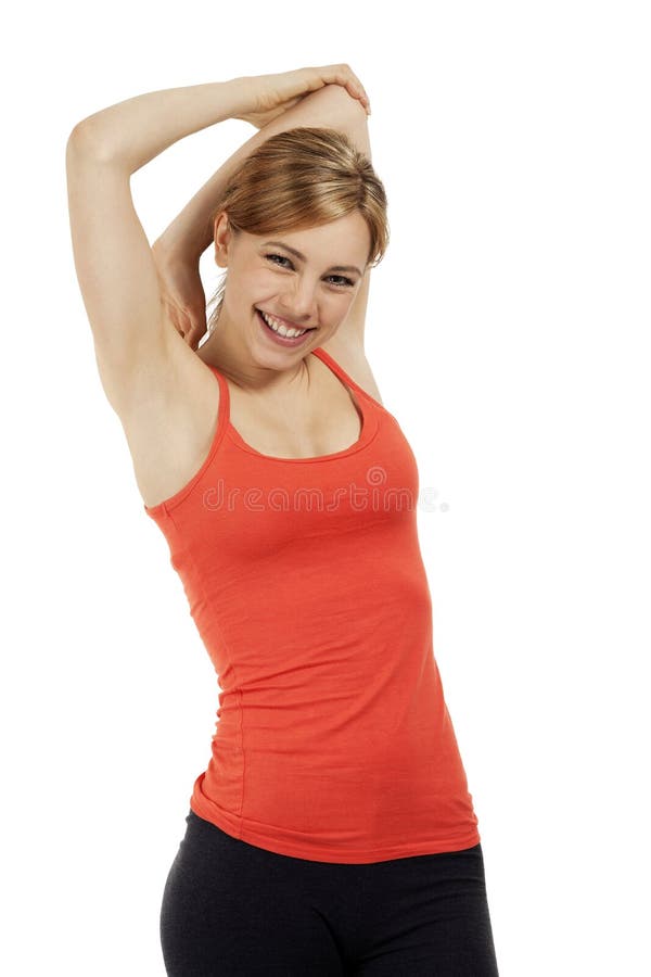 Young happy fitness woman in red shirt stretching her arms on white background. Young happy fitness woman in red shirt stretching her arms on white background