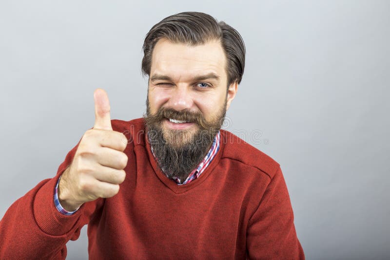 Gelukkige jonge O.K. teken met zijn duim tonen omhoog en mens die knipperen royalty-vrije stock afbeeldingen Gelukkige jonge O.K. teken met zijn duim tonen omhoog en mens die knipperen royalty-vrije stock afbeeldingen