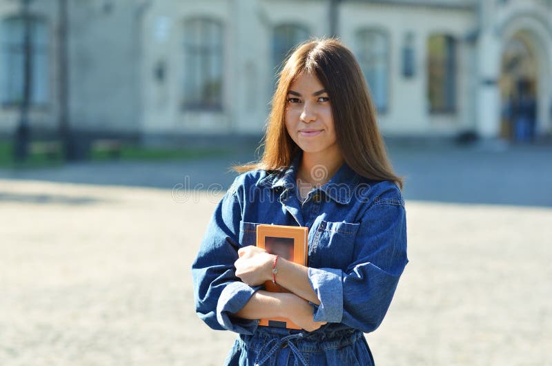 Gelukkige leuke jonge studenteholding boeken en het lopen royalty-vrije stock afbeelding Gelukkige leuke jonge studenteholding boeken en het lopen royalty-vrije stock afbeelding