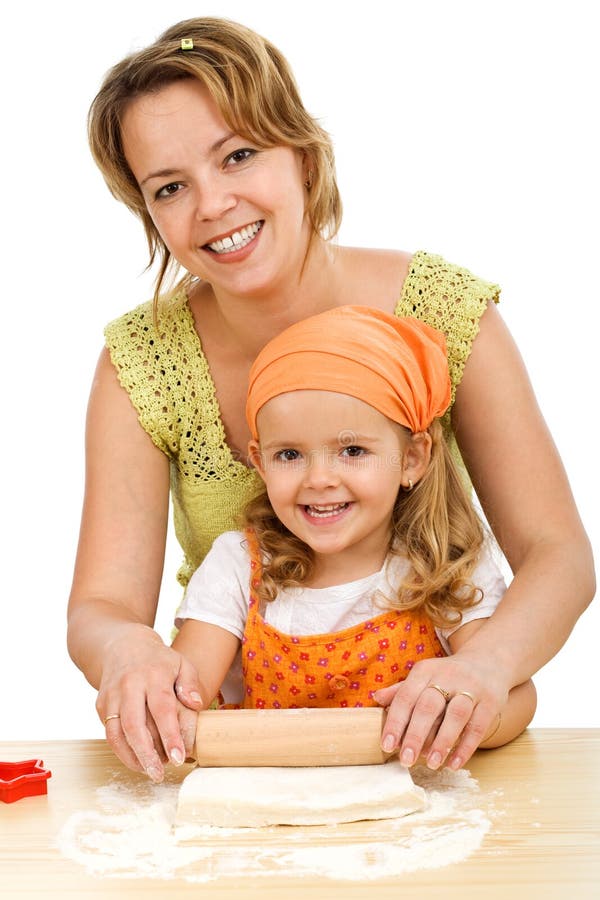 Happy woman and little girl stretching the dough together - isolated. Happy woman and little girl stretching the dough together - isolated