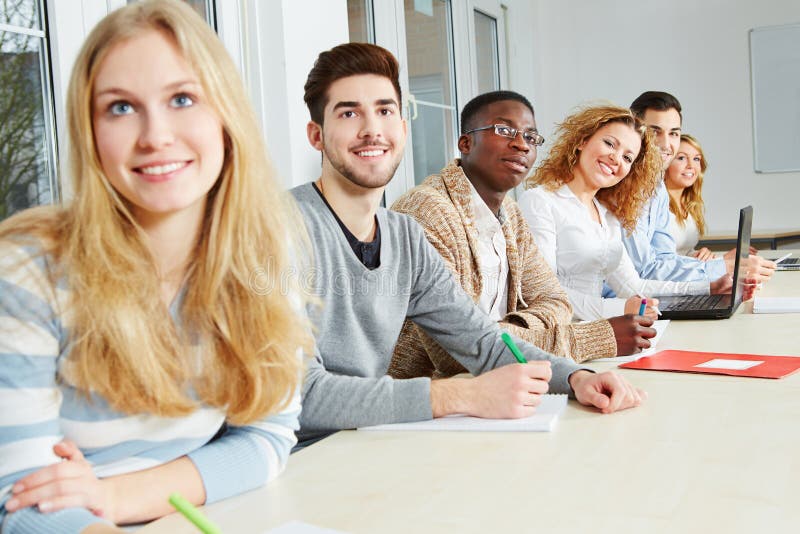 Happy students learning together in a university seminar. Happy students learning together in a university seminar