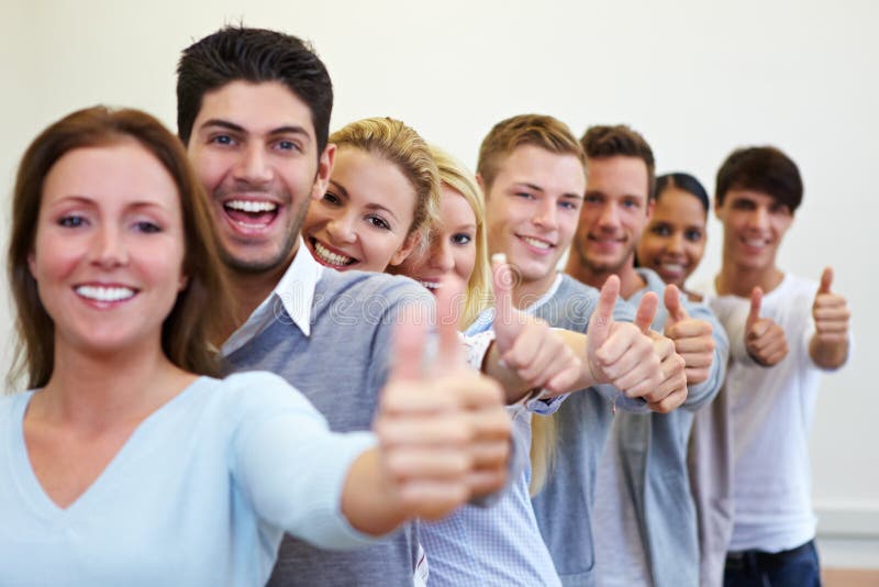 Happy smiling students in a row with their thumbs up. Happy smiling students in a row with their thumbs up