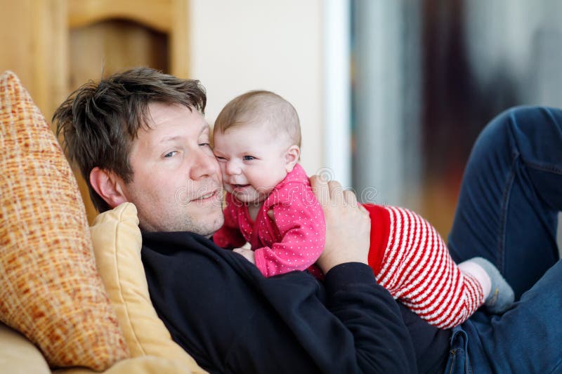 Gelukkige trotse jonge vader met pasgeboren babydochter, familieportret samen stock afbeelding Gelukkige trotse jonge vader met pasgeboren babydochter, familieportret samen stock afbeelding