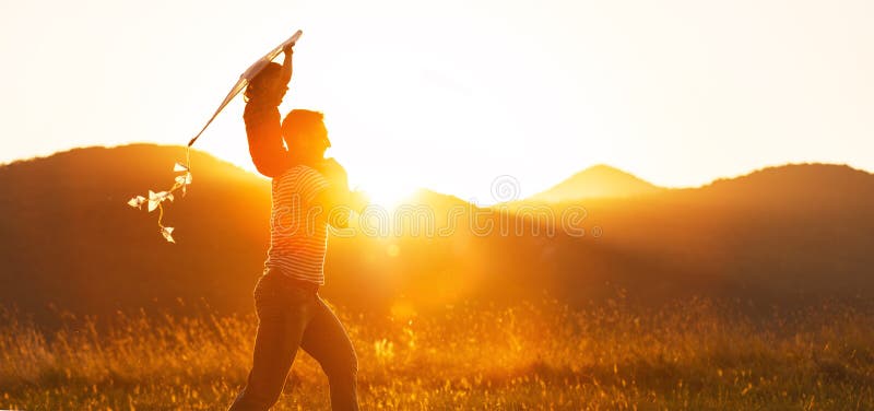 Happy father`s day! girl and dad with a kite on nature in summer. Happy father`s day! girl and dad with a kite on nature in summer