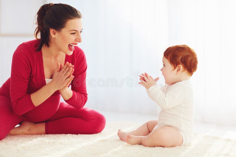 Gelukkige zwangere moeder en peuterbaby speelspelen die thuis, handen samen slaan stock foto's Gelukkige zwangere moeder en peuterbaby speelspelen die thuis, handen samen slaan stock foto's