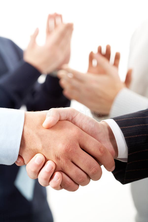 Photo of handshake of business partners after striking deal. Photo of handshake of business partners after striking deal