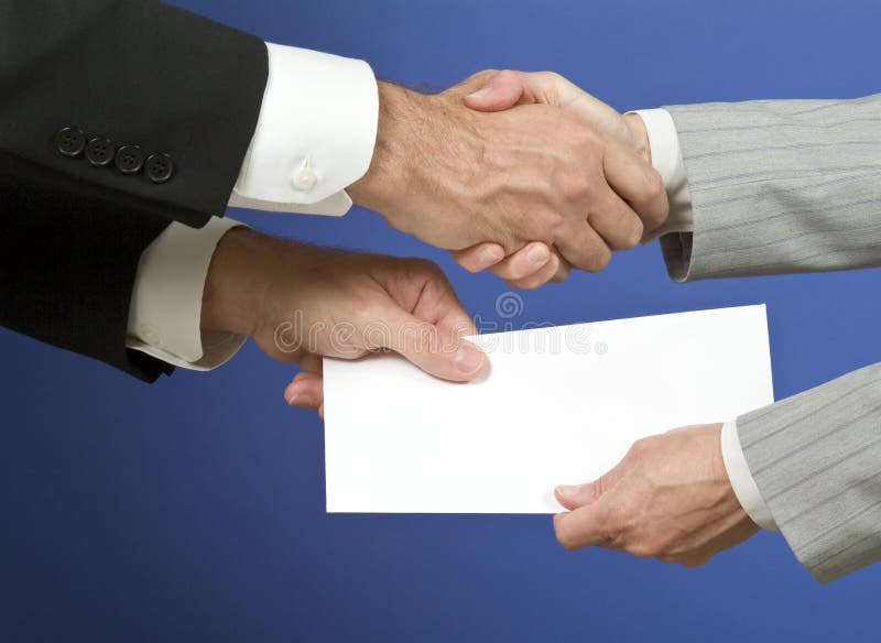 Two people shaking hands and exchanging a white envelope with available copy space for adding text. Two people shaking hands and exchanging a white envelope with available copy space for adding text.