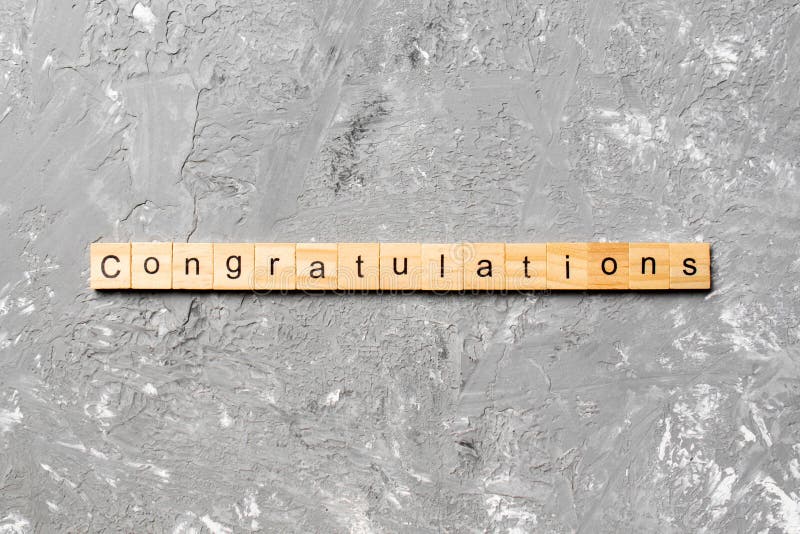 Congratulations word written on wood block. congratulations text on cement table for your desing, concept. Congratulations word written on wood block. congratulations text on cement table for your desing, concept.