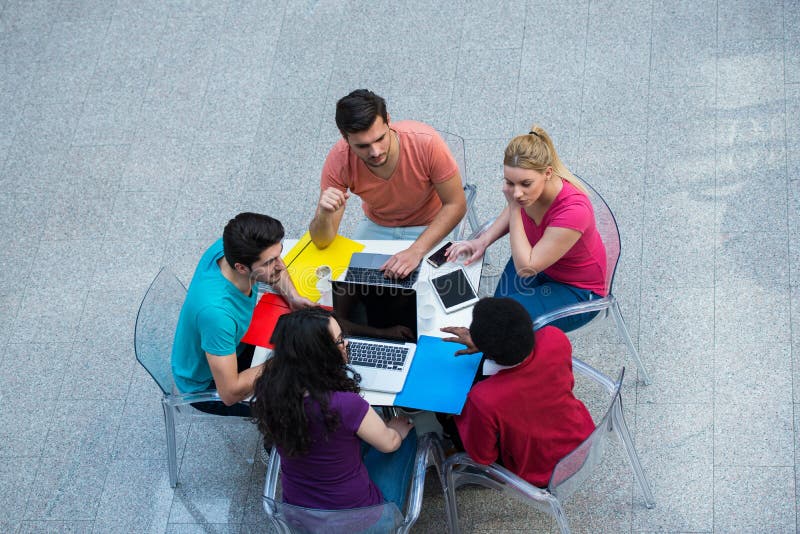 Gemischtrassige Gruppe junge Studenten, die zusammen studieren Schuss des hohen Winkels von den jungen Leuten, die am Tisch sitze stockfotos Gemischtrassige Gruppe junge Studenten, die zusammen studieren Schuss des hohen Winkels von den jungen Leuten, die am Tisch sitze stockfotos