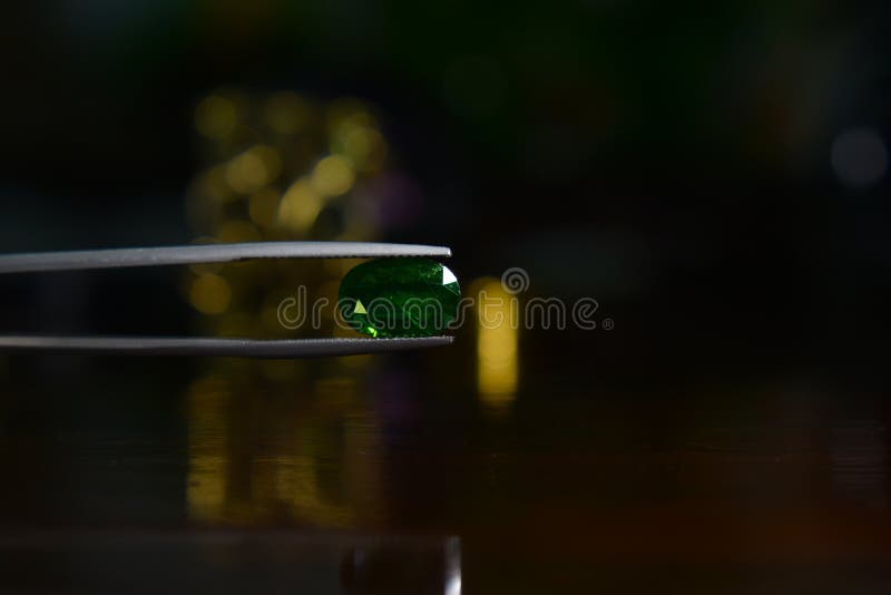 Gems and jewelry are A beautiful green gemstone for making elegant stock photography