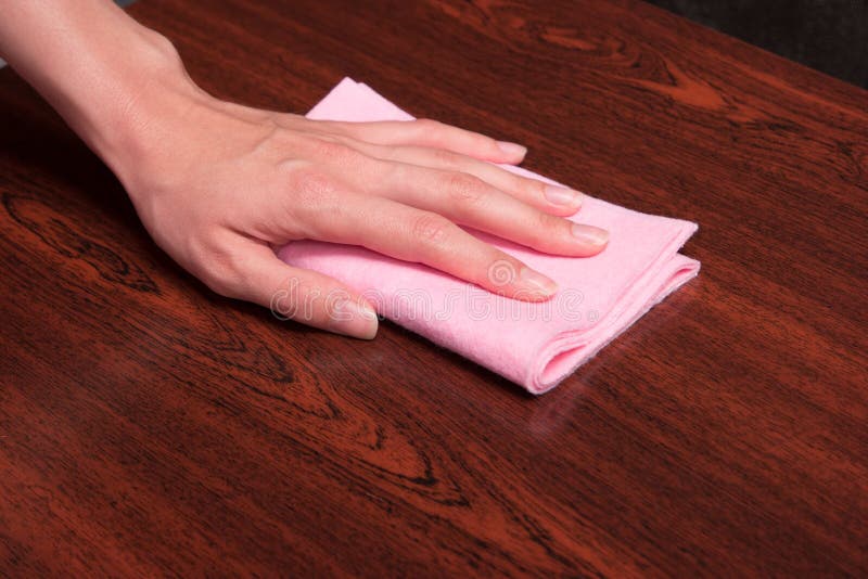 General cleaning of the house. Wiping wooden shelf from dust. royalty free stock images General cleaning of the house. Wiping wooden shelf from dust. royalty free stock images