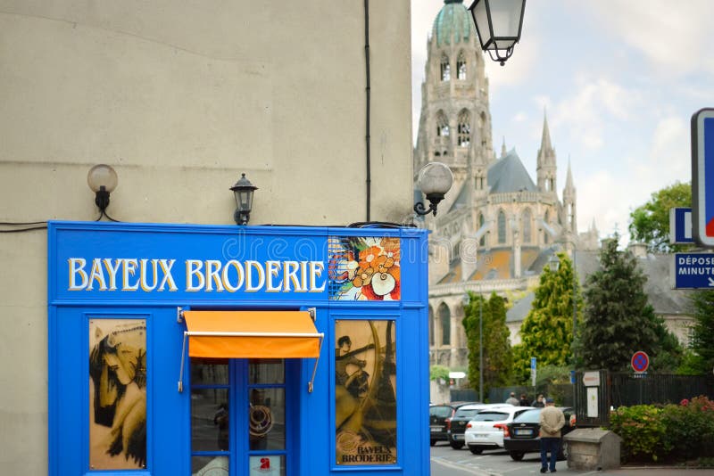 A general view of the Bayeux Broderie Shop sign with the historic Cathedral in view, in the historic town of Bayeux France royalty free stock photos A general view of the Bayeux Broderie Shop sign with the historic Cathedral in view, in the historic town of Bayeux France royalty free stock photos