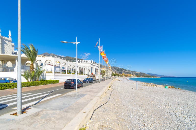 General view of the Casino Barrière flags and sign along the coast of the French Riviera at Menton, France stock images General view of the Casino Barrière flags and sign along the coast of the French Riviera at Menton, France stock images